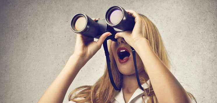 woman with binoculars examines her mortgage