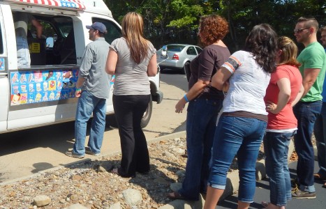 Employees wait patiently for ice cream in the summer sun.