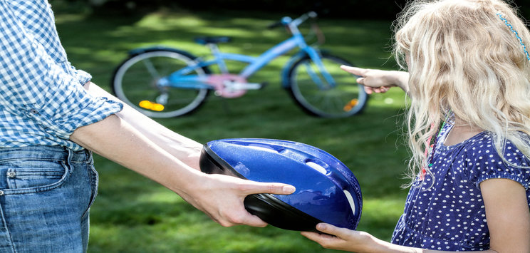 father offers helmet to protect daughter