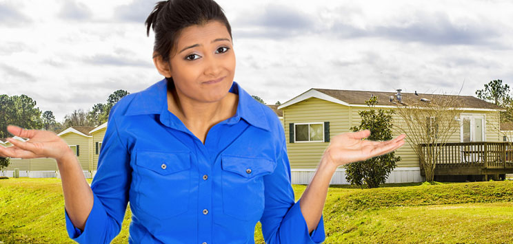 woman looking confused in front of manufactured home