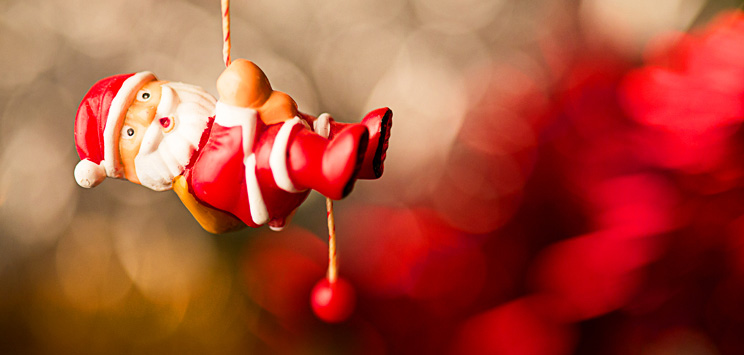 santa hanging by a thread due to holiday debt